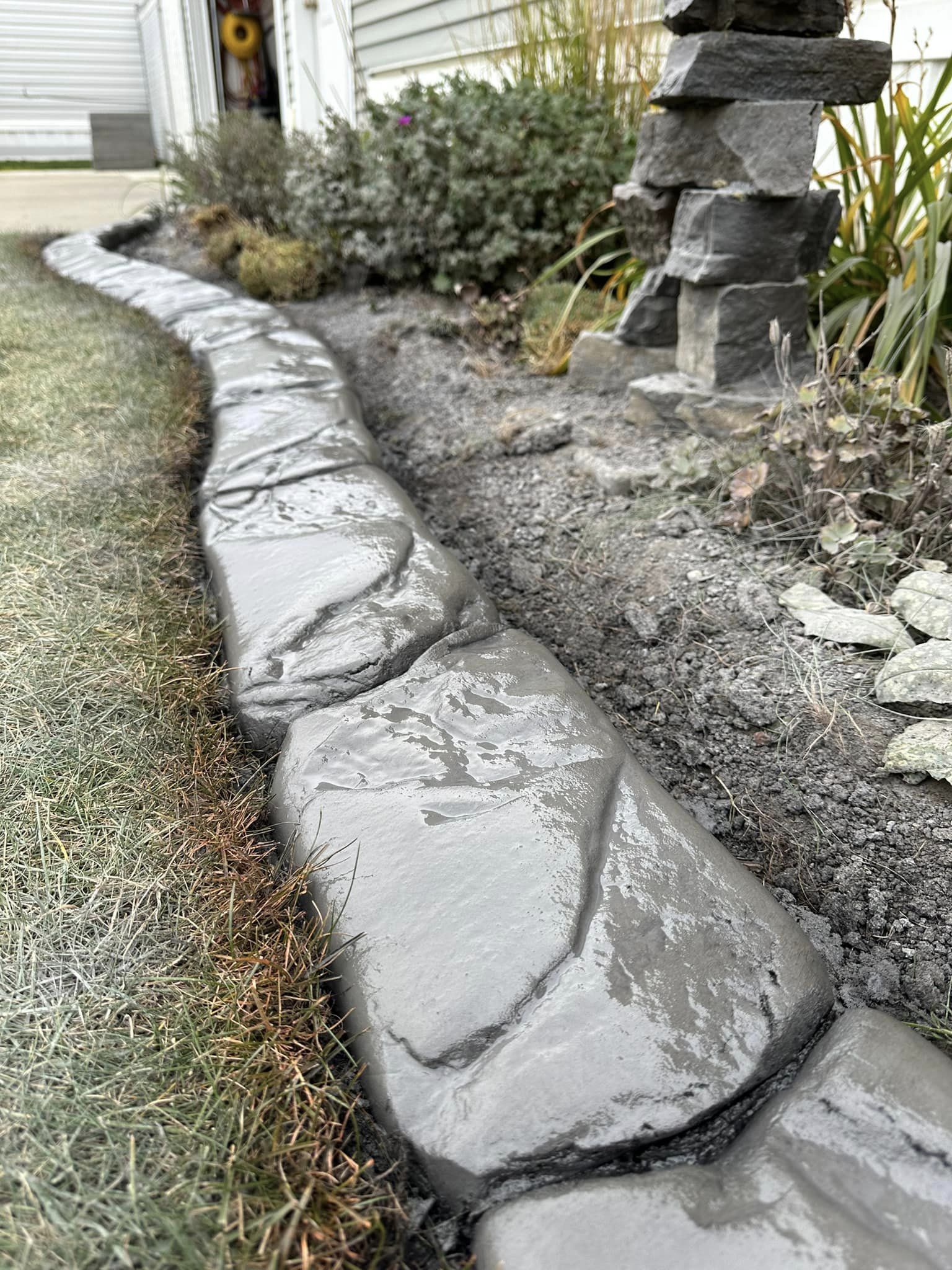 Image of hand carved curbing at a customer's front garden bed of their home.