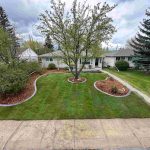 JBs Custom Curbing shows a finished project with sod and curbing.