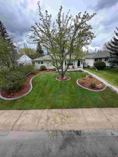 JBs Custom Curbing shows a finished project with sod and curbing.